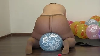 A fat girl in pantyhose sits down on balloons and pisses