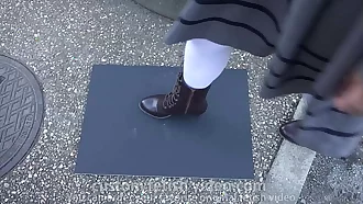 Girl puts boots prints on paper